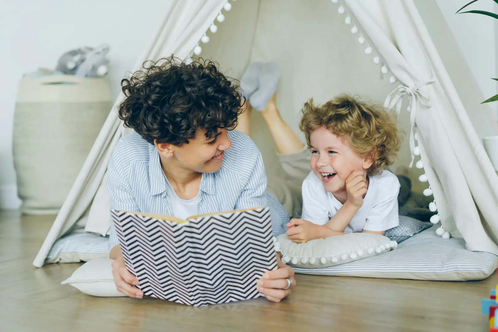 reading to a child in a play fort