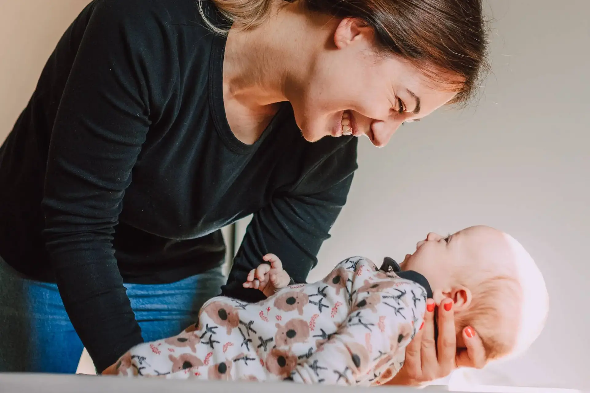 choice-cares-process-to-finding-newborn-help women gently putting newborn down to sleep