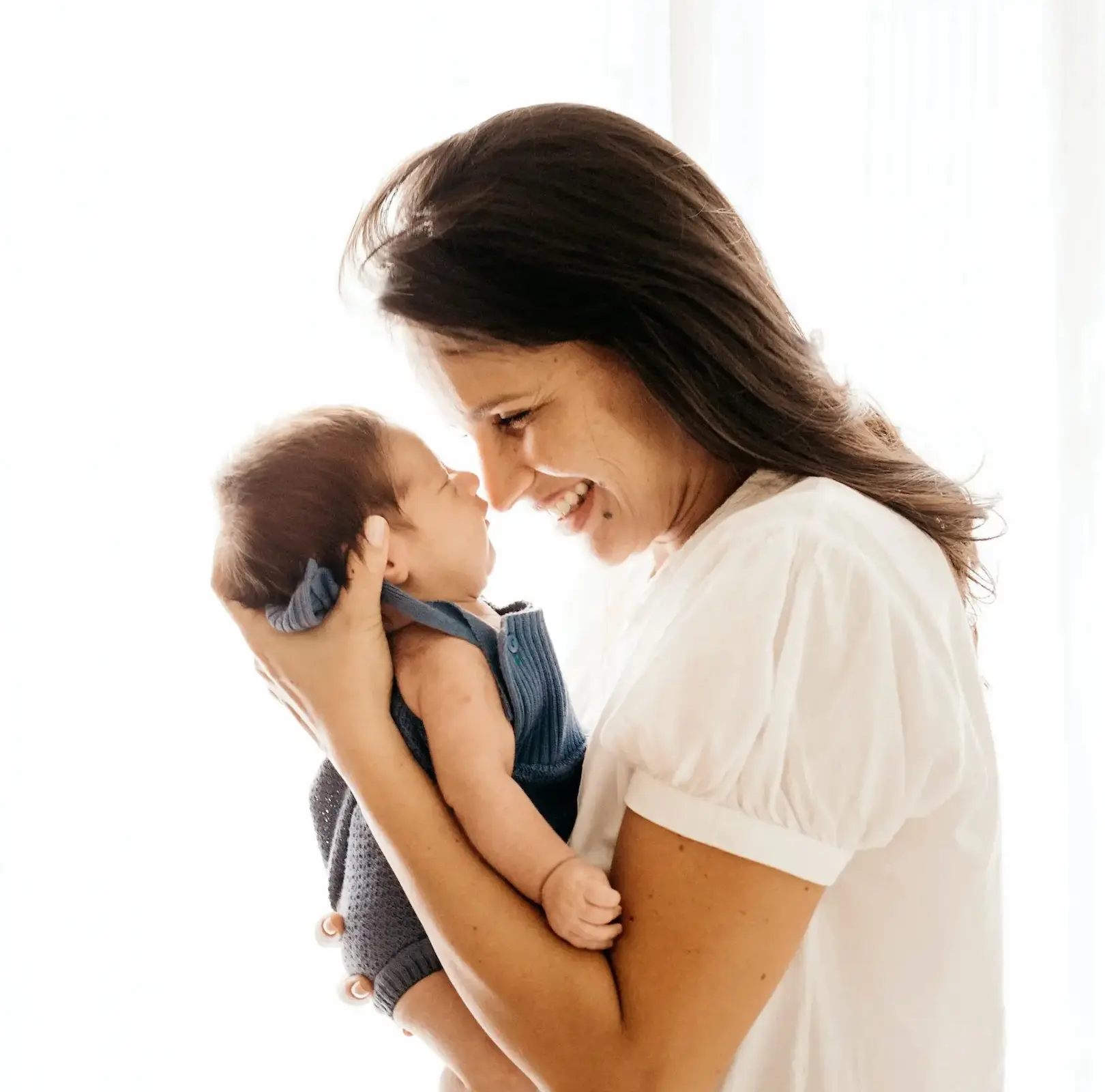 newborn-babys-safety-matters woman smiling at baby
